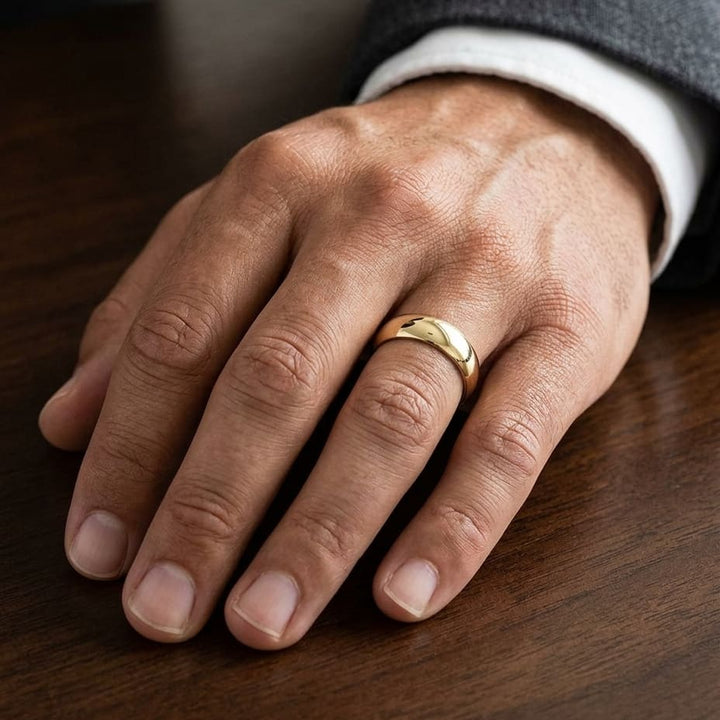 7mm Slightly Domed Comfort-Fit Wedding Band in 14K Yellow Gold, worn on hand, masculine close-up