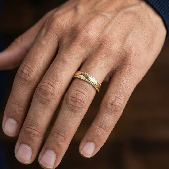 5mm Slightly Domed Double Milgrain Comfort-Fit Wedding Band in 14K Yellow Gold, worn on hand, masculine close-up