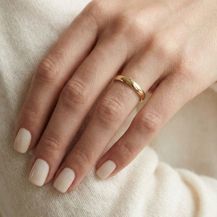 3mm Slightly Domed Super Light Comfort-Fit Wedding Band in 14K Yellow Gold, worn on hand, close-up