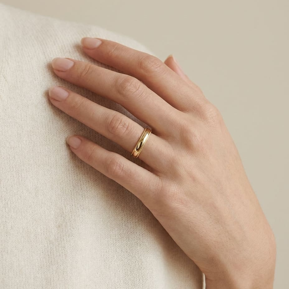 4mm Slightly Domed Super Light Milgrain Comfort-Fit Wedding Band in 14K Yellow Gold, worn on hand, full view