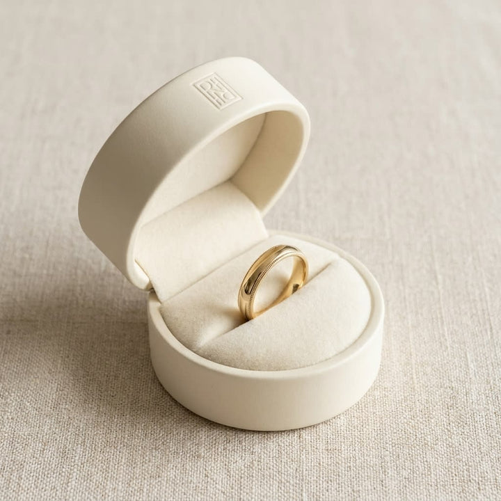 4mm Slightly Domed Super Light Milgrain Comfort-Fit Wedding Band in 14K Yellow Gold, in navy velvet jewelry box
