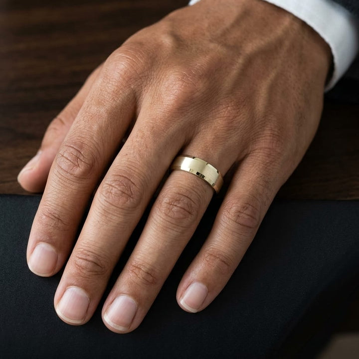7mm Satin Finish High Polished Beveled Edge Carved Wedding Band in 14K Yellow Gold, worn on hand, masculine close-up