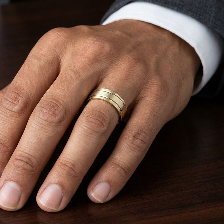 8mm Satin Finish Parallel Groove Carved Wedding Band in 14K Yellow Gold, worn on hand, masculine close-up