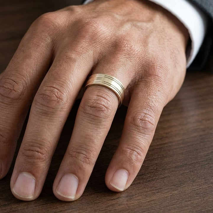 7mm Satin Finish Parallel Groove Carved Wedding Band in 14K Yellow Gold, worn on hand, masculine close-up