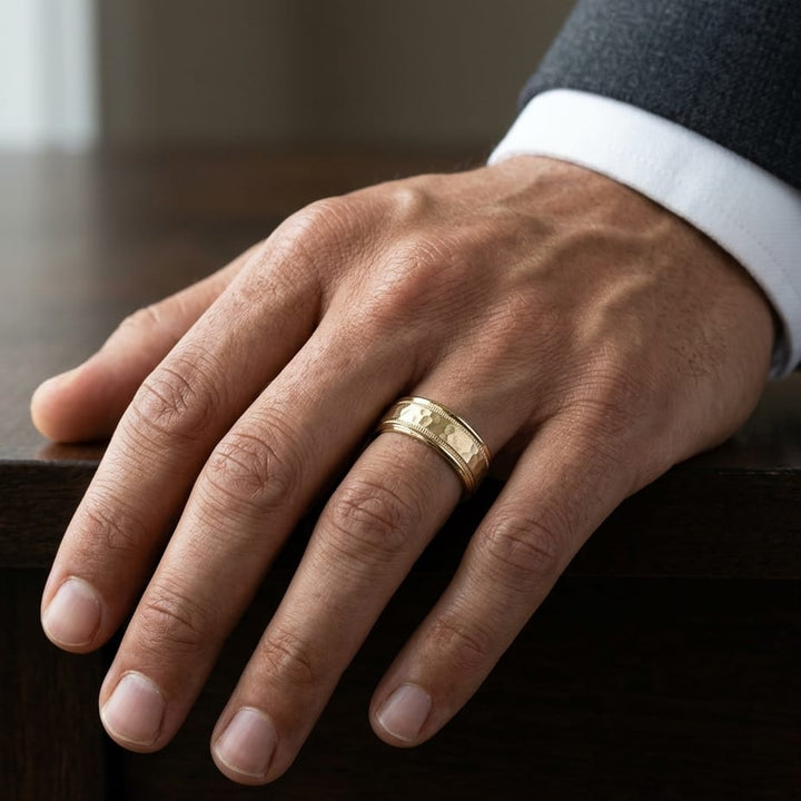 8mm Hammered Center High Polish Round Edge Carved Wedding Band in 14K Yellow Gold, worn on hand, masculine close-up