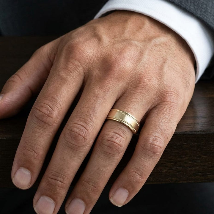 8mm Satin Finish Milgrain Round Edge Carved Wedding Band in 14K Yellow Gold, worn on hand, masculine close-up