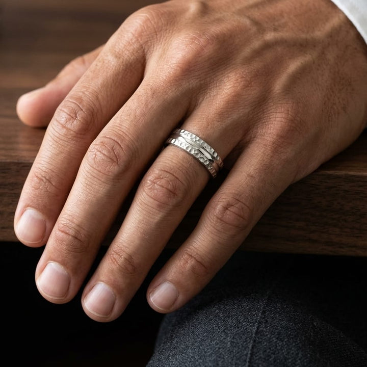 7.5mm Hammered Finish Carved Wedding Band in 14K Yellow Gold, worn on hand, masculine close-up