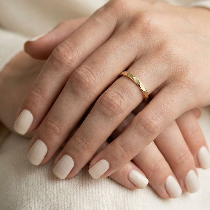 2mm High Polish Carved Wedding Band in 14K Yellow Gold, worn on hand, close-up
