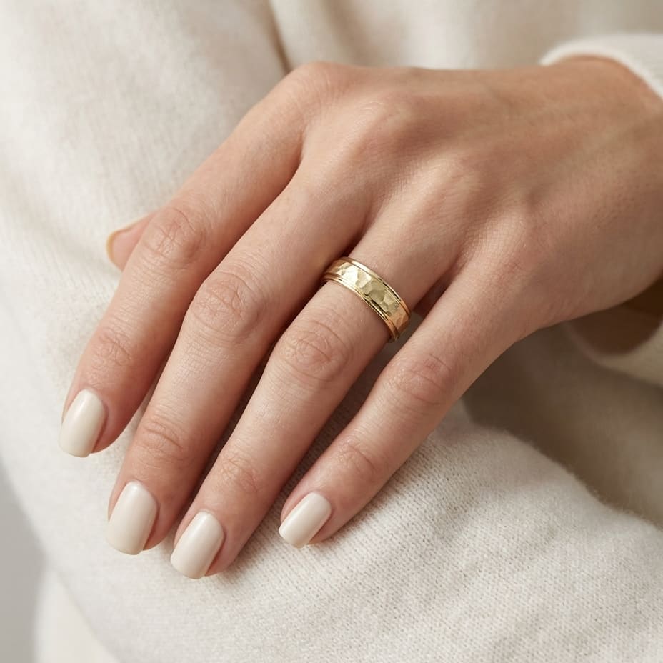 4mm Hammered Finish Carved Wedding Band in 14K Yellow Gold, worn on hand, close-up