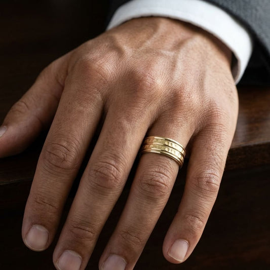 7.5mm High Polish Round Edge Carved Wedding Band in 14K Yellow Gold, worn on hand, masculine close-up