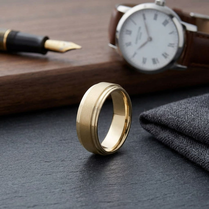 8mm Satin Finish Carved Wedding Band in 14K Yellow Gold, on walnut surface with pocket square