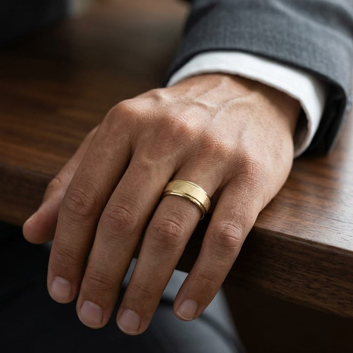 7mm Round Edge Swirl Finish Carved Wedding Band in 14K Yellow Gold, worn on hand, masculine close-up