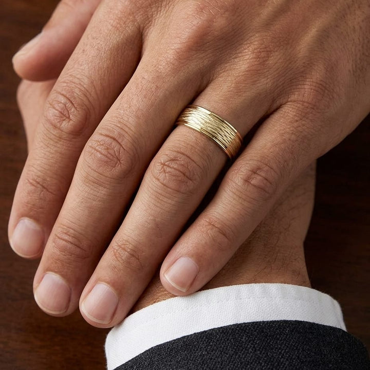 7.5mm Comfort-Fit Wedding Band in 14K Yellow Gold, worn on hand, masculine close-up