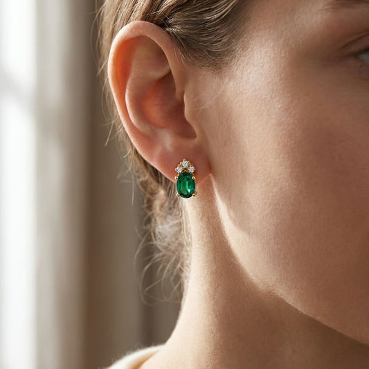 Created Emerald Round Brilliant Stud Earrings in 14K Yellow Gold, worn close-up portrait