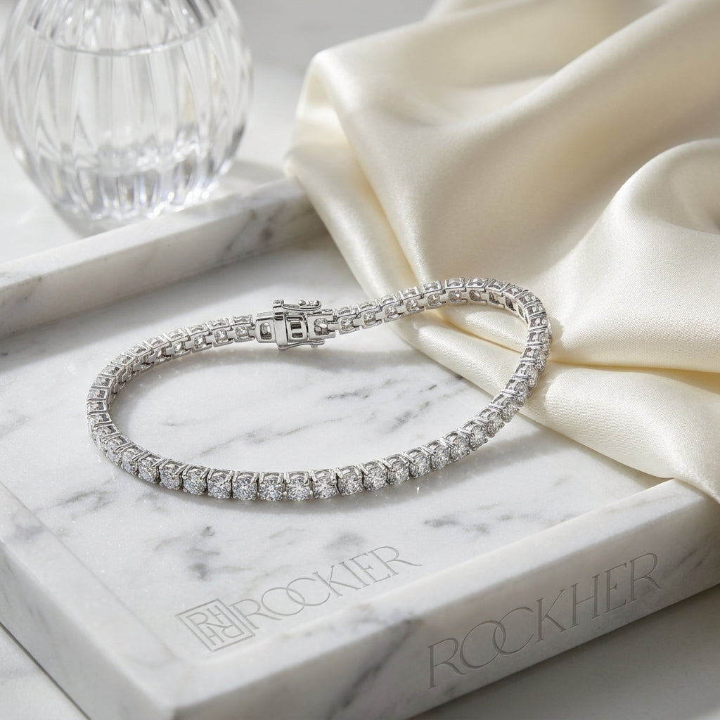 Diamond 4-prong Tennis Bracelet In Platinum (3mm), on marble vanity tray with silk