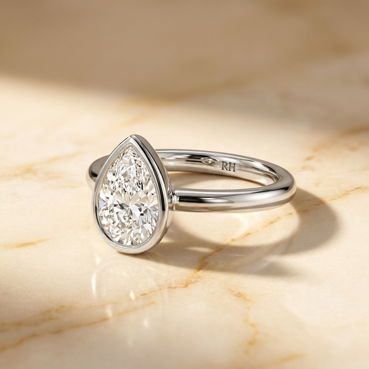 The Agnes Select bezel solitaire pear engagement ring in platinum — alt-angle hero — RockHer
