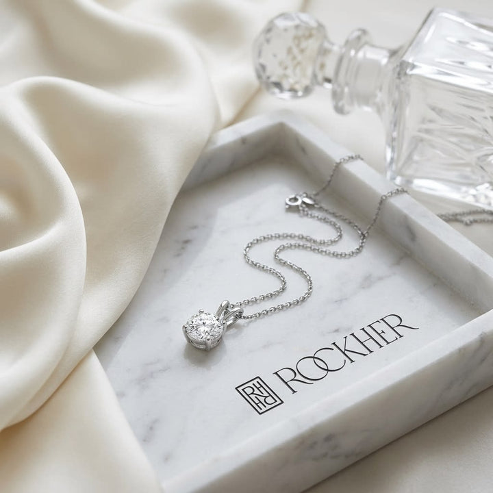 Natural Diamond Round Brilliant Solitaire Pendant in Platinum, 4 ct. t.w., on marble vanity tray with silk