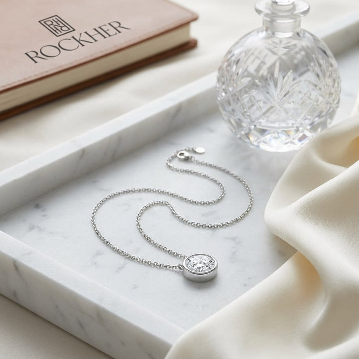 Natural Diamond Round Brilliant Solitaire Pendant in Platinum, 1 ct. t.w., on marble vanity tray with silk