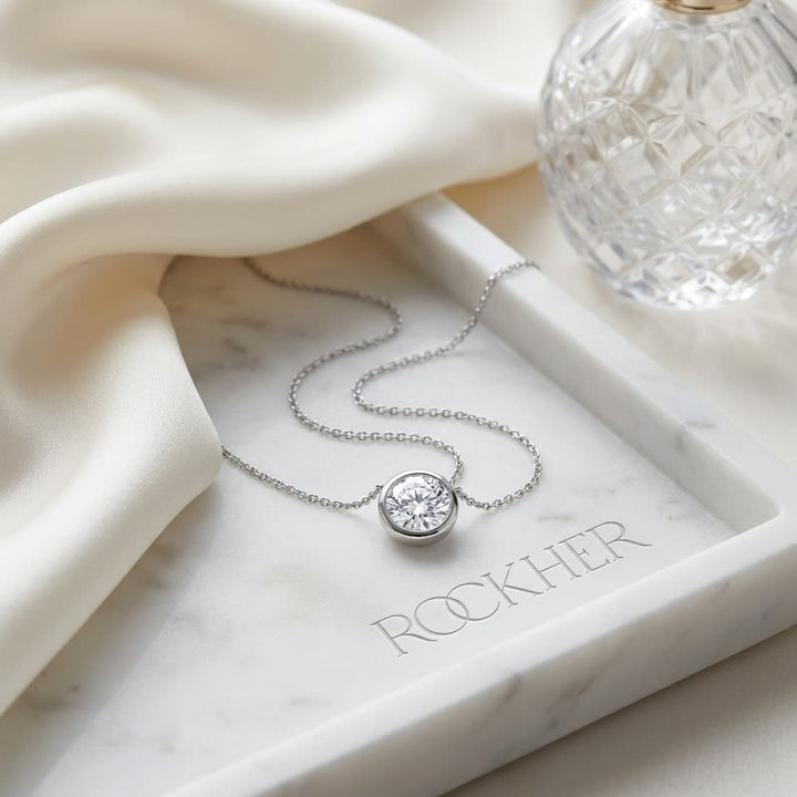 Natural Diamond Round Brilliant Solitaire Pendant in Platinum, 1 ct. t.w., on marble vanity tray with silk