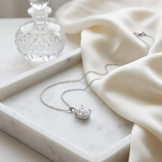Natural Diamond Oval Solitaire Pendant in Platinum, 2 ct. t.w., on marble vanity tray with silk
