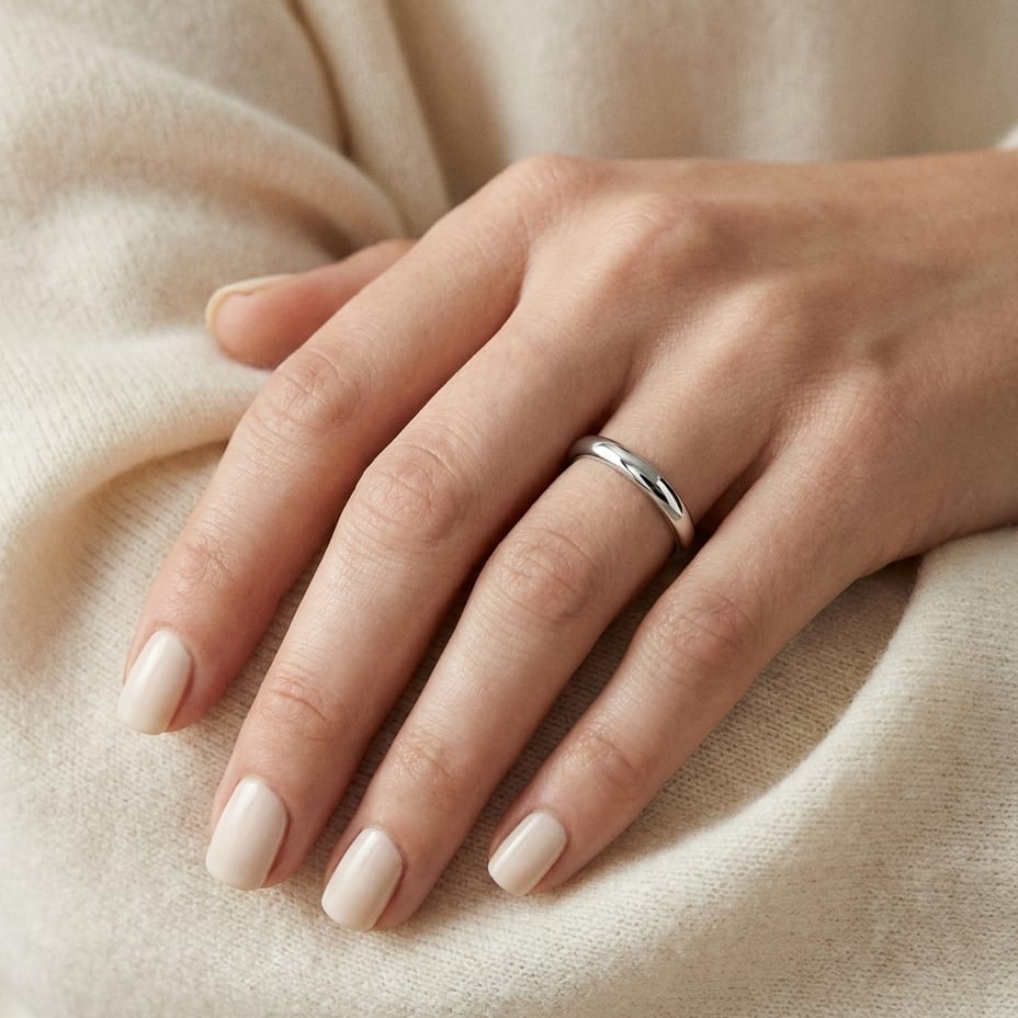 2mm Slightly Domed Traditional Oval Wedding Band in Platinum, worn on hand, close-up