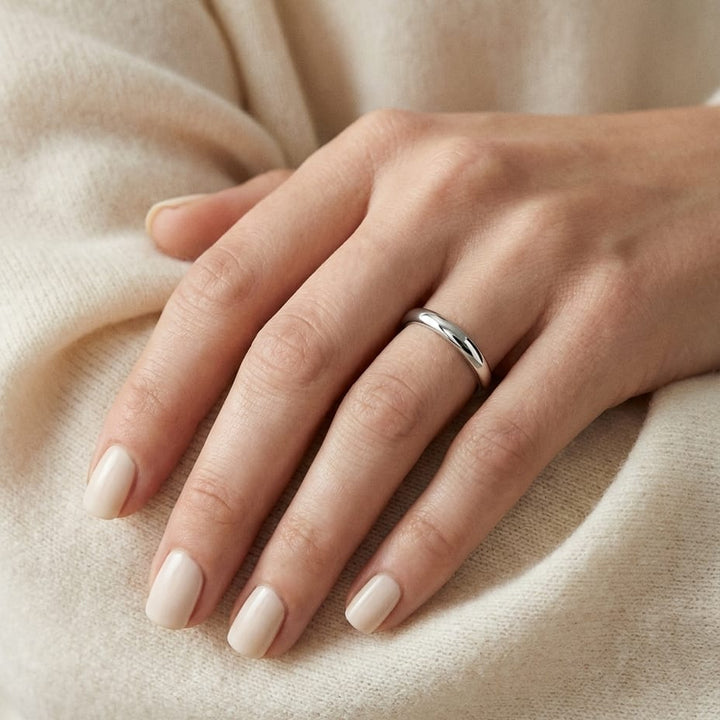 2mm Slightly Domed Traditional Oval Wedding Band in Platinum, worn on hand, close-up