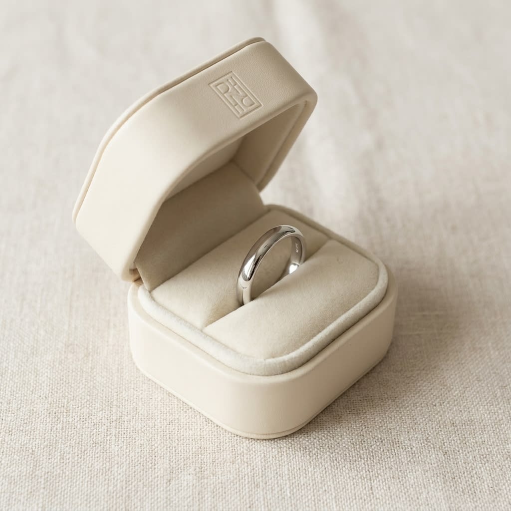 2.5mm Slightly Domed Traditional Oval Wedding Band in Platinum, in navy velvet jewelry box