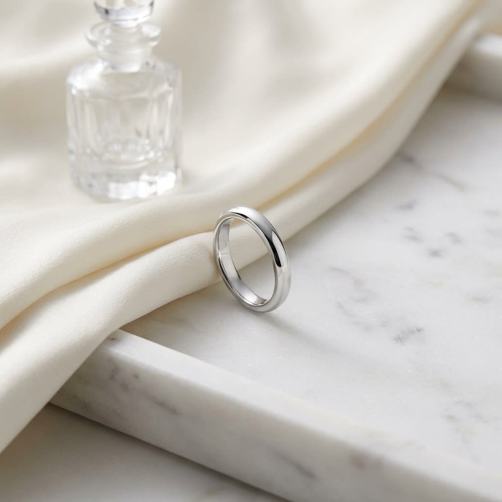 3mm Slightly Domed Traditional Oval Wedding Band in Platinum, on marble vanity tray with silk