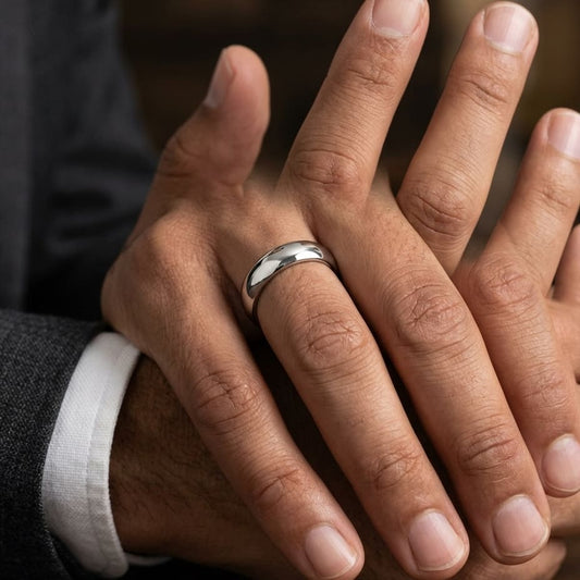 5mm Slightly Domed Traditional Oval Wedding Band in Platinum, worn on hand, masculine close-up