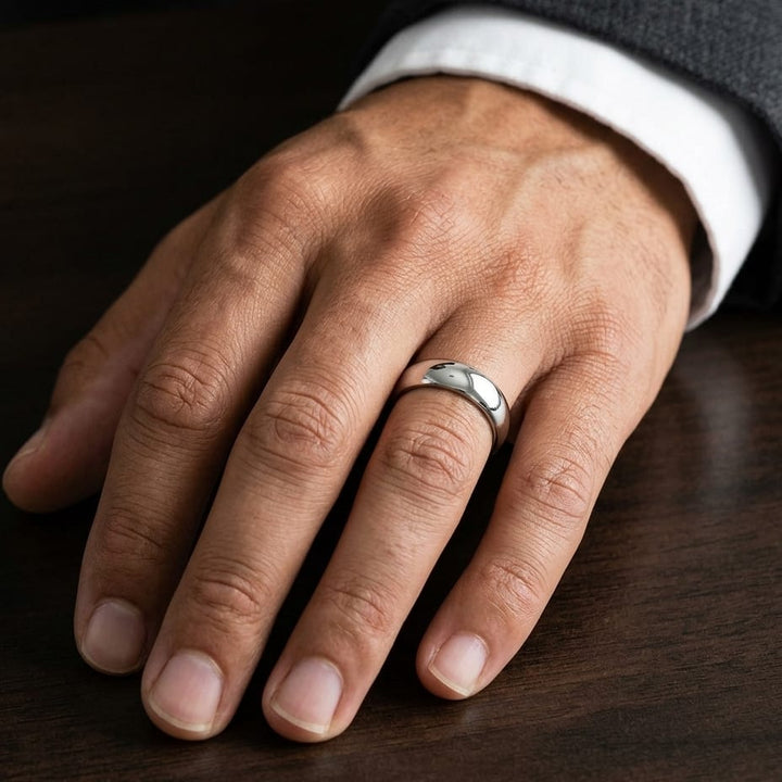 6mm Slightly Domed Traditional Oval Wedding Band in Platinum, worn on hand, masculine close-up