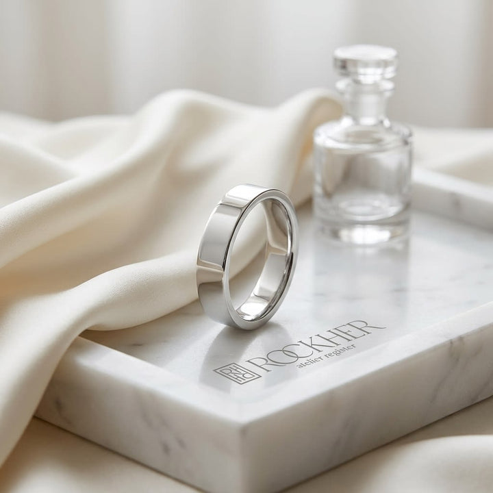 4mm Flat Comfort-Fit Wedding Band in Platinum, on marble vanity tray with silk