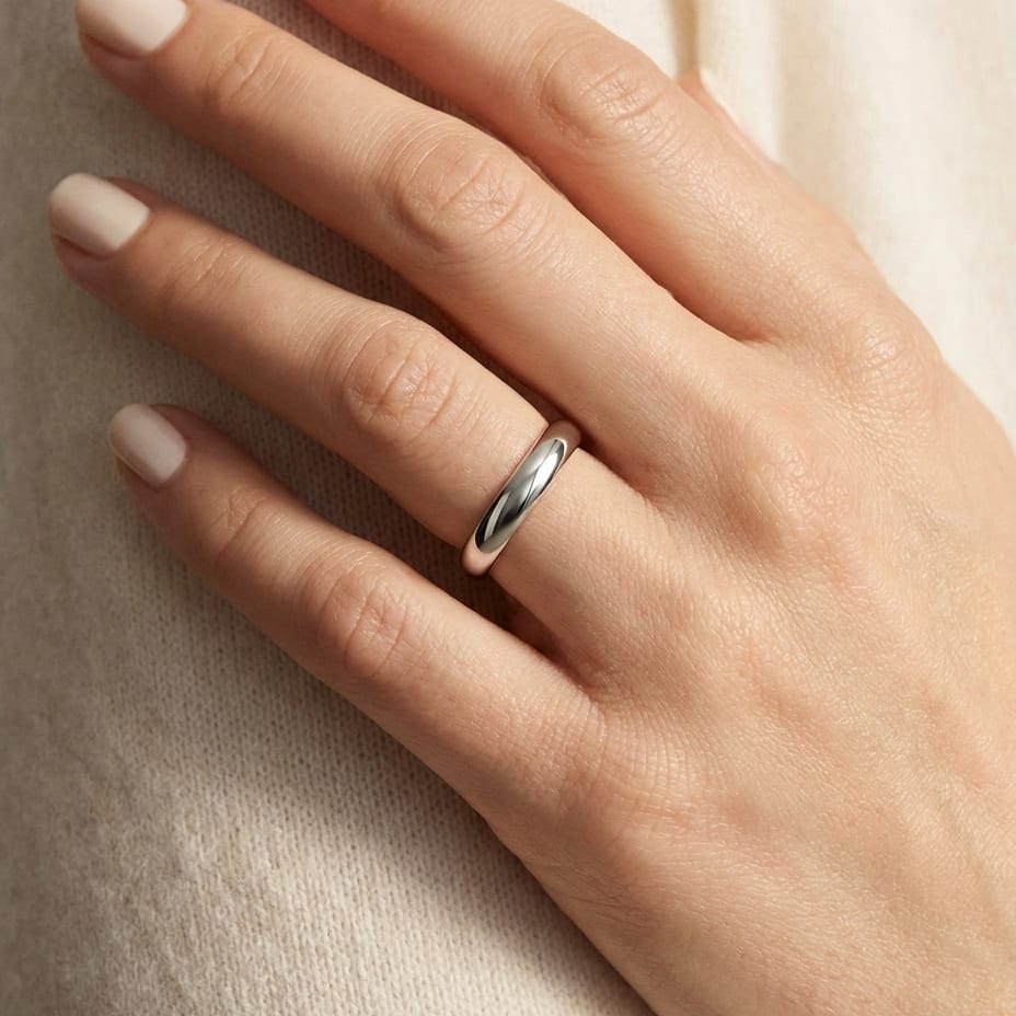 4mm High Dome Comfort-Fit Wedding Band in Platinum, worn on hand, close-up