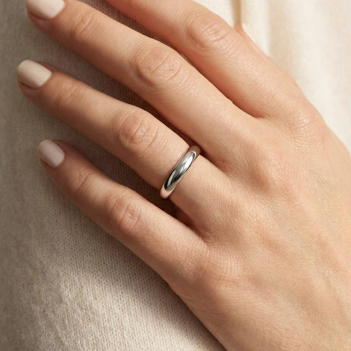 4mm High Dome Comfort-Fit Wedding Band in Platinum, worn on hand, close-up