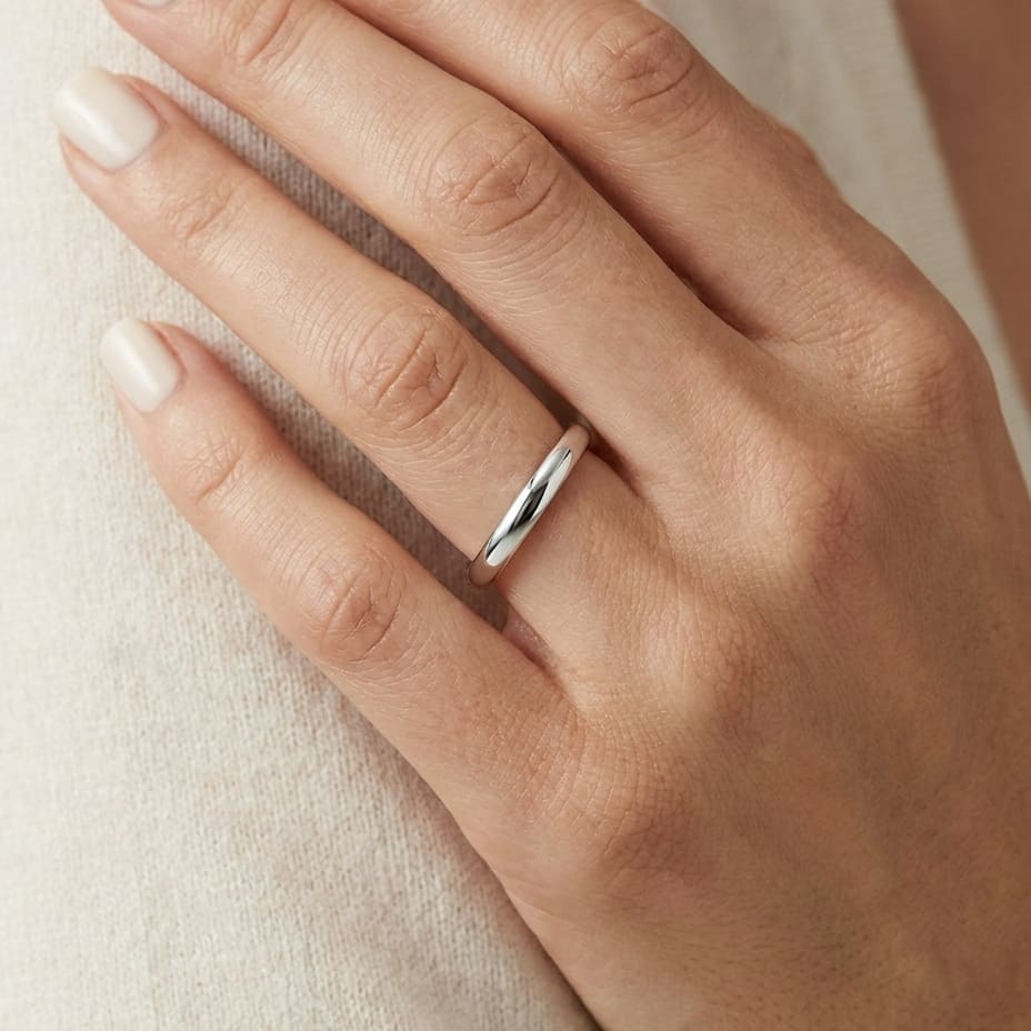 2.5mm Slightly Domed Comfort-Fit Wedding Band in Platinum, worn on hand, close-up