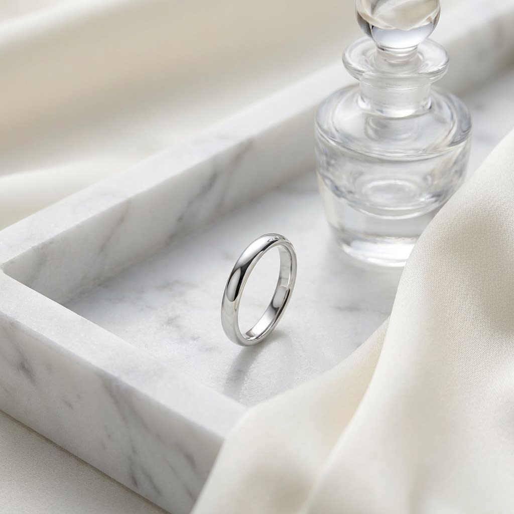 2.5mm Slightly Domed Comfort-Fit Wedding Band in Platinum, on marble vanity tray with silk