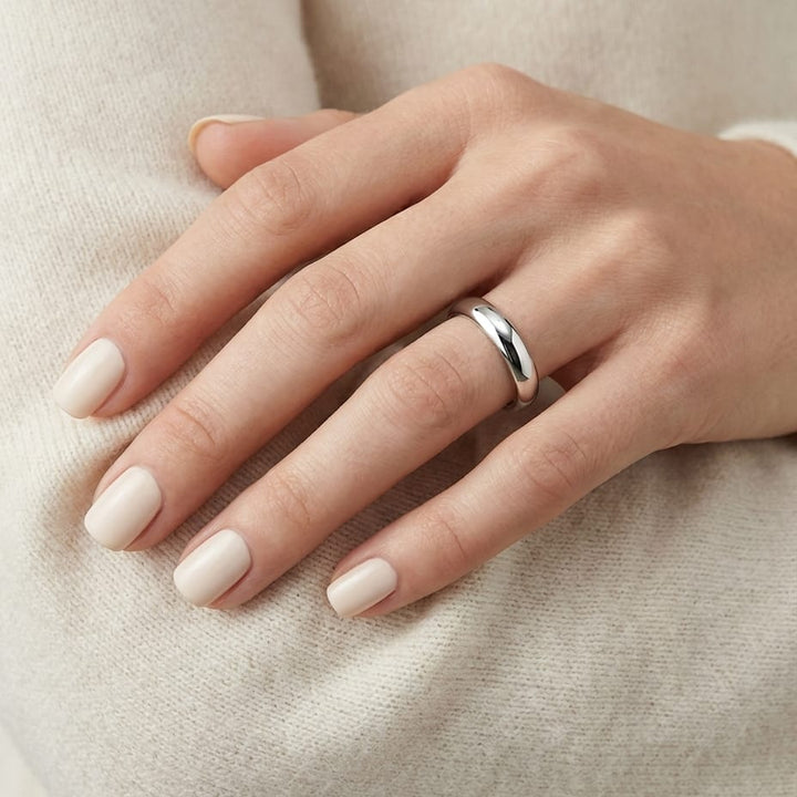 4mm Slightly Domed Comfort-Fit Wedding Band in Platinum, worn on hand, close-up