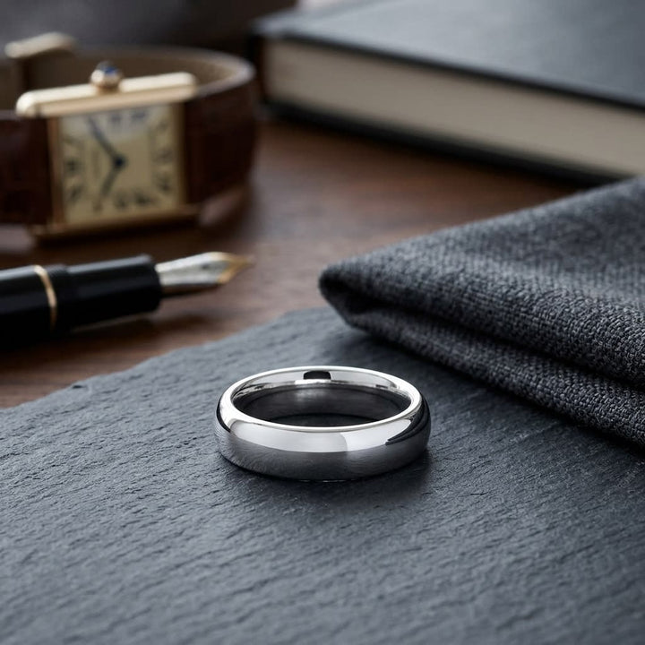 6mm Slightly Domed Comfort-Fit Wedding Band in Platinum, on walnut surface with pocket square