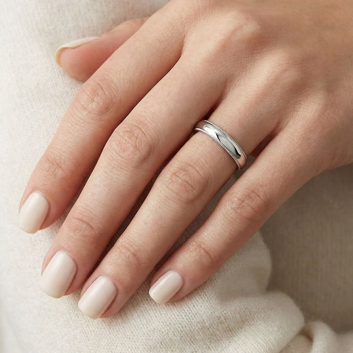 4mm Slightly Domed Milgrain Comfort-Fit Wedding Band in Platinum, worn on hand, close-up