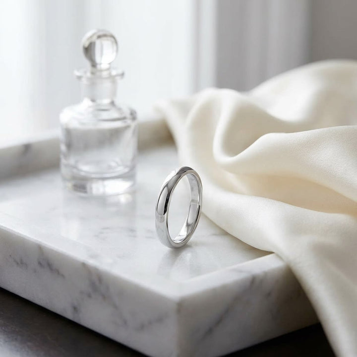 4mm Slightly Domed Super Light Comfort-Fit Wedding Band in Platinum, on marble vanity tray with silk