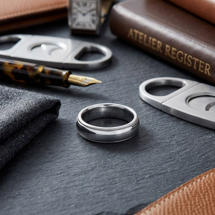 5mm Slightly Domed Super Light Milgrain Comfort-Fit Wedding Band in Platinum, on walnut surface with pocket square