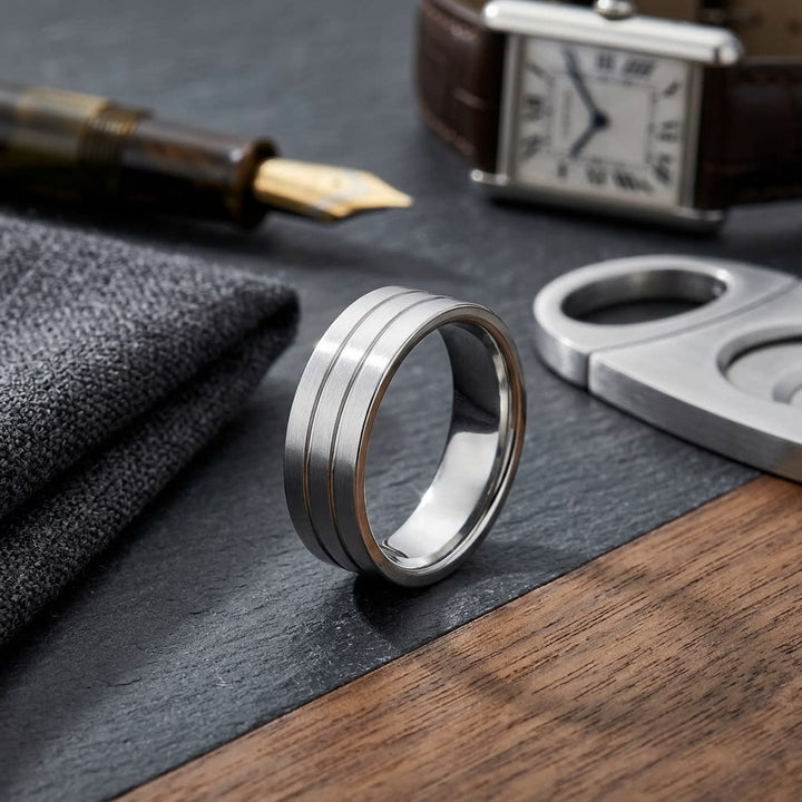 6mm Satin Finish Parallel Center Cut Carved Wedding Band in Platinum, on walnut surface with pocket square