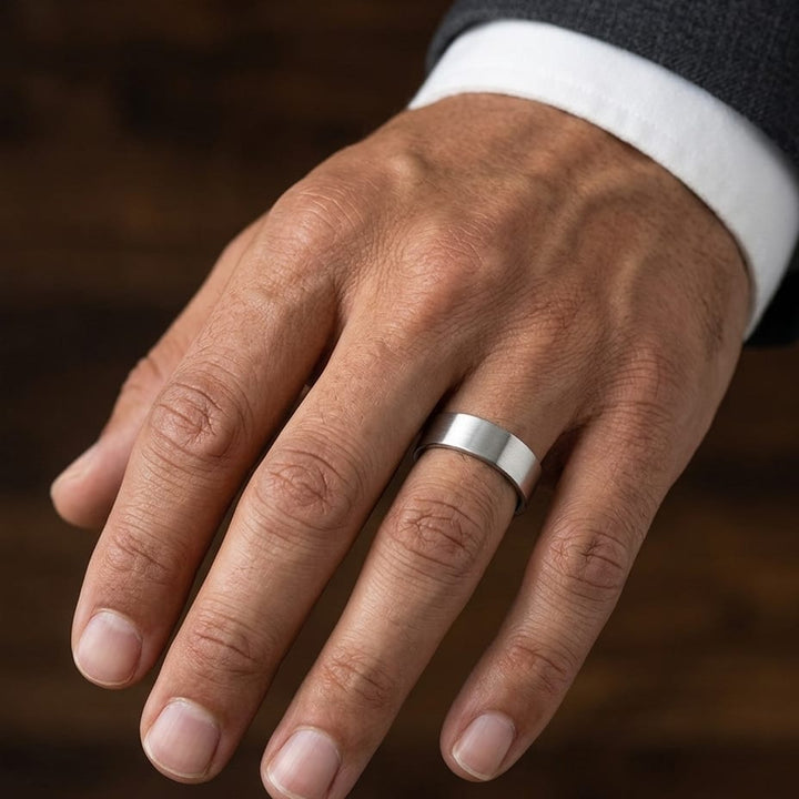 6mm Satin Finish Carved Wedding Band in Platinum, worn on hand, masculine close-up