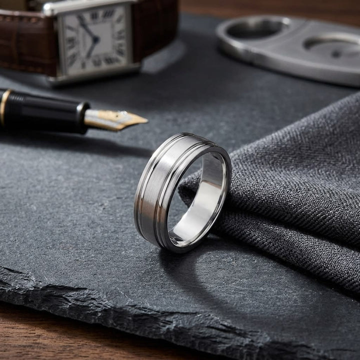 6mm Satin Finish Parallel Groove Carved Wedding Band in Platinum, on walnut surface with pocket square