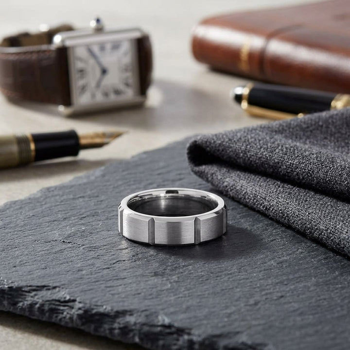 6mm Satin Finish Grooves Carved Wedding Band in Platinum, on walnut surface with pocket square