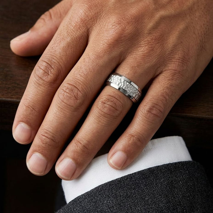 7.5mm Hammered Finish Beveled Edge Carved Wedding Band in Platinum, worn on hand, masculine close-up