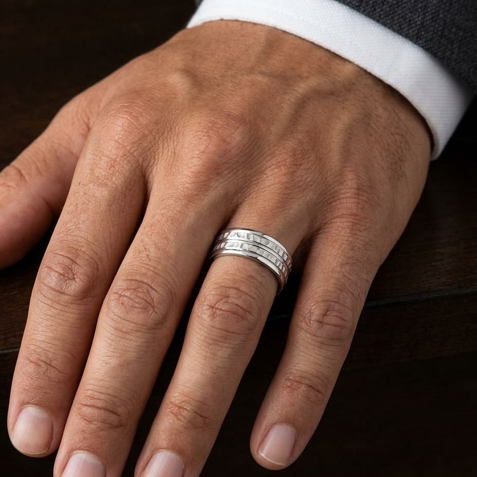 7.5mm High Polish Round Edge Carved Wedding Band in Platinum, worn on hand, masculine close-up
