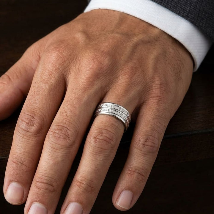 7.5mm High Polish Round Edge Carved Wedding Band in Platinum, worn on hand, masculine close-up