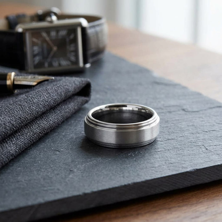 8mm Satin Finish Carved Wedding Band in Platinum, on walnut surface with pocket square