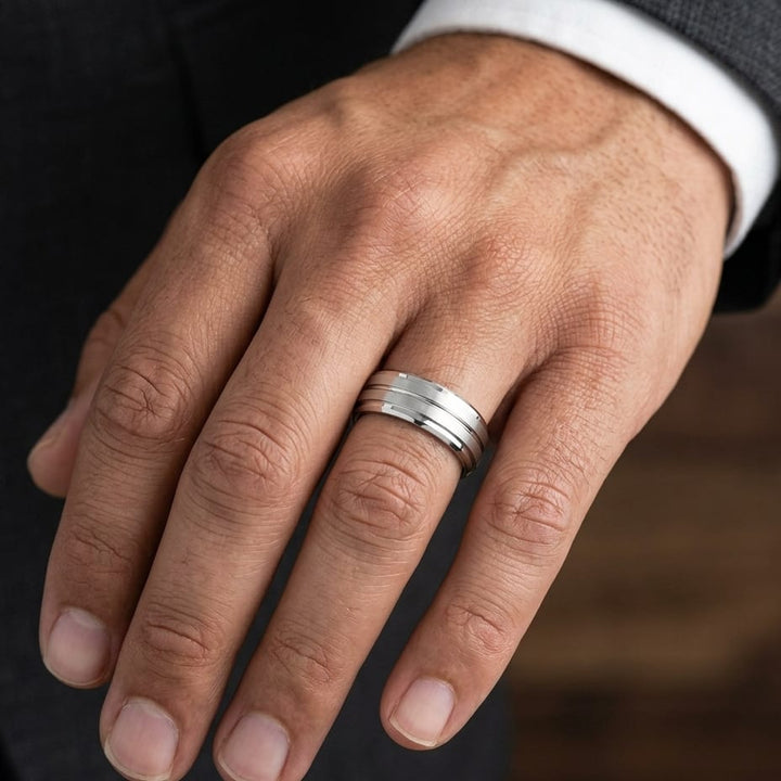 8mm Satin Finish High Polished Center Cut Carved Wedding Band in Platinum, worn on hand, masculine close-up