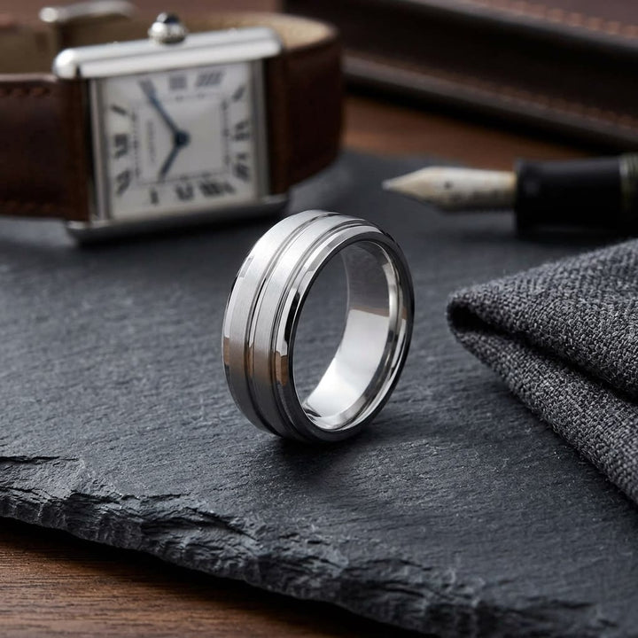 8mm Satin Finish High Polished Center Cut Carved Wedding Band in Platinum, on walnut surface with pocket square